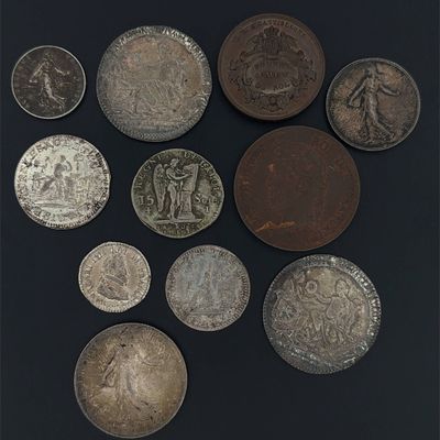 an assortment of silver and bronze coins on a black surface