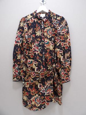 the shirt is hanging on a hanger on the wall