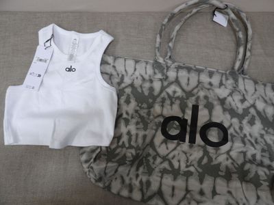 a bag and a t - shirt sitting on a couch