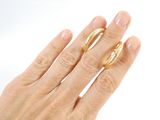 a woman ' s hand with a gold ring on it