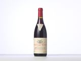 a bottle of red wine sitting on top of a table