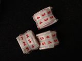 three dice pieces with numbers on them sitting on a table