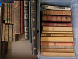 many old books in a box on the floor