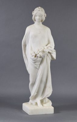 statue of a woman holding a basket of flowers