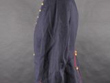a blue jacket with red buttons on a mannequin base