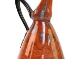 a red pitcher with a black handle on a white background
