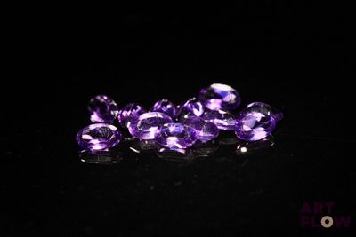 purple amethorate beads on a black surface