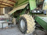 a green tractor that is parked in a building
