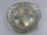 a silver plate on a table with a white background