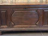 a wooden chest with a clock on top of it