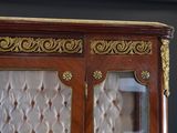 a wooden cabinet with a mirror on top of it