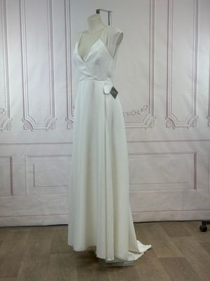 a photo of a white dress on a mannequin stand