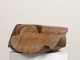 wooden sculpture of a cloud on a white pedestal against a white wall