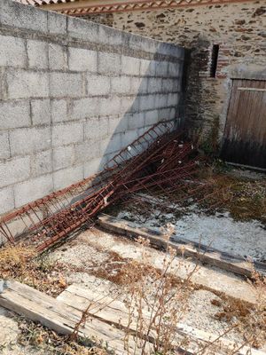 a building that has a lot of rust on the ground