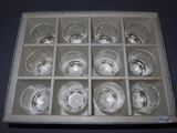a box with six glasses of water inside of it