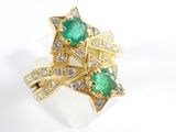 an image of a close up of a ring with a green stone