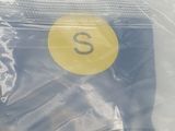 a plastic bag with a yellow sticker on it