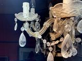 a glass chandelier that is hanging from the ceiling
