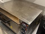 stainless steel counter top with a toaster oven sitting on top of it