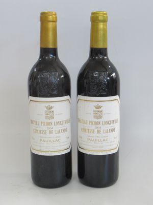 two bottles of wine sitting next to each other on a table