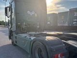 a semi truck that is parked on the side of the road