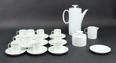 a lot of cups and saucers sitting on a table