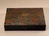 an old wooden box with a decorative design on the lid