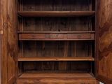 a wooden cabinet with a door open in a room