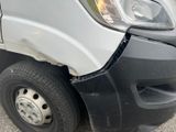 a white van that has a dent in the front of it