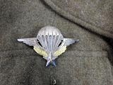 a picture of a badge with a parachute on it