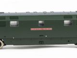 a green train on the tracks on a white background