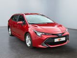 the red toyota corollant is parked in a large room