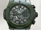the watch is green with a black face and a black rubber strap