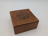 an old wooden box with a design on the lid