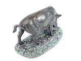 statue of a bull on a rock with a white background