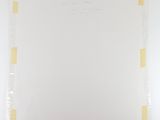 a close up of a piece of white paper with yellow squares