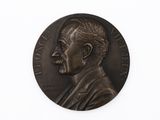 une vieille médaille en bronze sur laquelle figure le visage d'un homme
