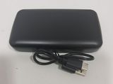 a black power bank with a usb cable attached to it