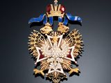 an image of a gold and blue broochle with a star on it