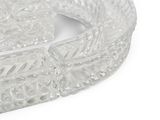 a clear glass bowl with a handle on a white surface