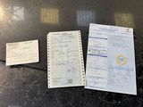 two papers and a pen sitting on a table