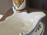 a white and blue bowl and saucer on a wooden table