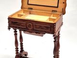 a small wooden table with a drawer on top of it
