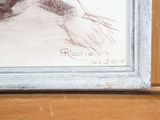 a picture of a drawing of a woman ' s face in a picture frame