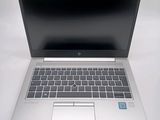 an open laptop computer sitting on top of a white table