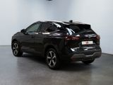 the rear end of a black suv parked in a garage