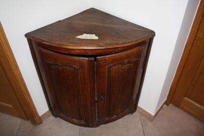a corner cabinet in the corner of a room