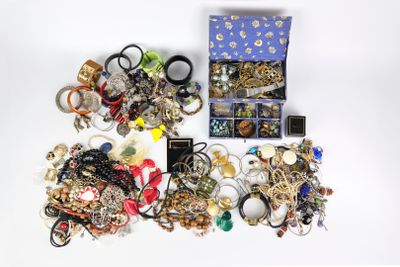 a box of assorted jewelry on a white surface