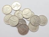 a close up of a pile of coins on a white surface