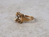 an image of a gold ring with a diamond on it
